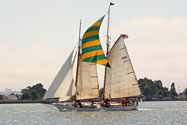 Large Sailboat with Green and Yellow Mast